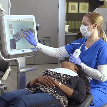 Dentist scanning smile during Invisalign treatment planning