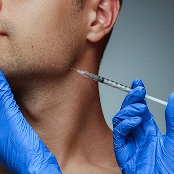 a person receiving a BOTOX injection in their jaw muscle