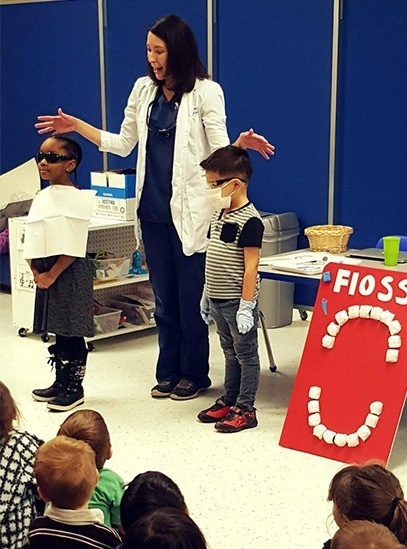 Dentist giving presentation to kids
