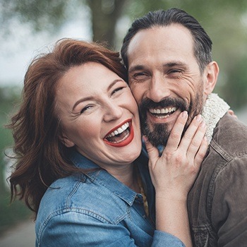 Man and woman with beautiful smiles after cosmetic dentistry