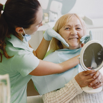 Chesterton patient smiling at dentist after getting dentures