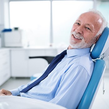 Older man smiling in dental chair