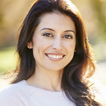 Woman with healthy teeth and gums after periodontal therapy