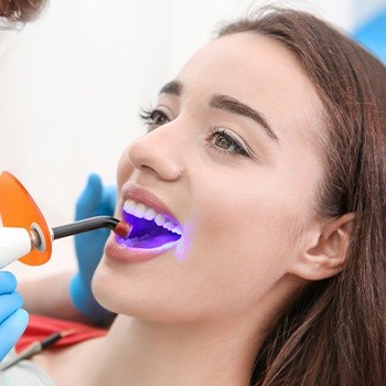 Young woman receiving dental sealants