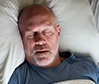 Snoring man in need of sleep apnea therapy
