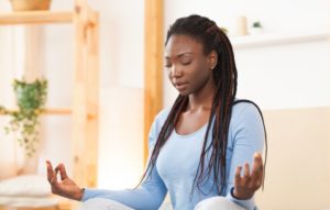 Woman in blue meditating