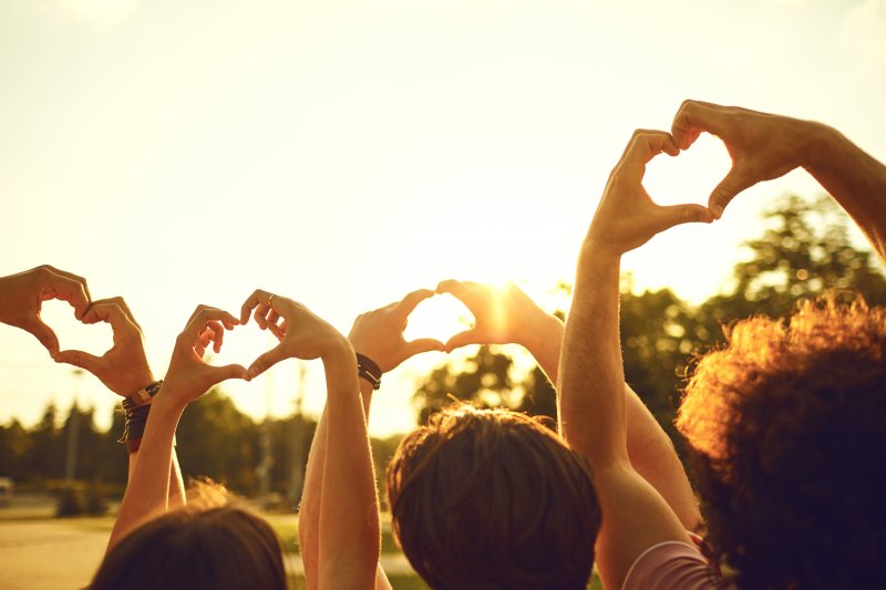 people making a heart with their hands