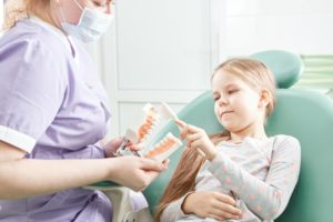 dental hygienist educating patient