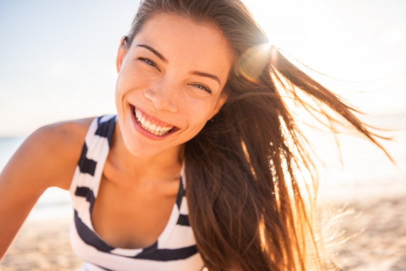 Happy woman smiling on beach