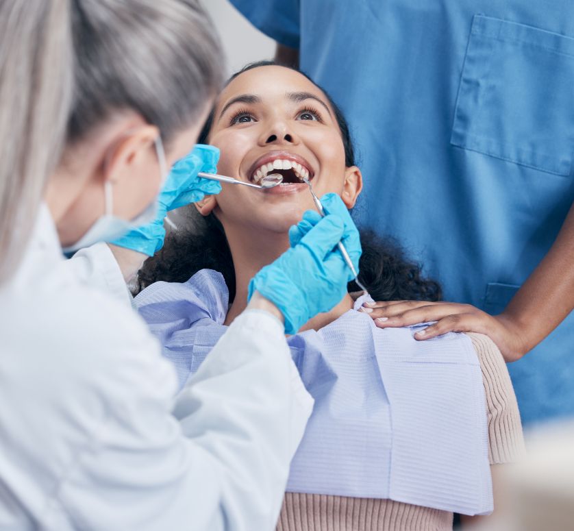 A woman getting a dental exam and cleaning