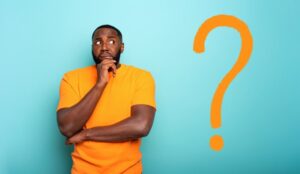 Man looking unsure with giant question mark next to him.